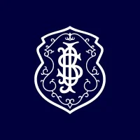 Um monograma "SI" branco, ornamentado e interligado dentro de um escudo decorativo em um fundo azul escuro simboliza o espírito do Integrativo.