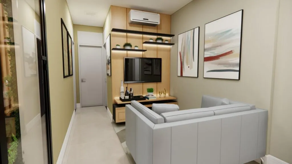 O Projeto Pinheiros apresenta uma sala de estar moderna com um sofá cinza, TV montada na parede e arte abstrata. Prateleiras de madeira clara exibem graciosamente plantas e decoração. Um ar condicionado fica acima da TV, complementando as paredes neutras e o piso de cerâmica perfeitamente.